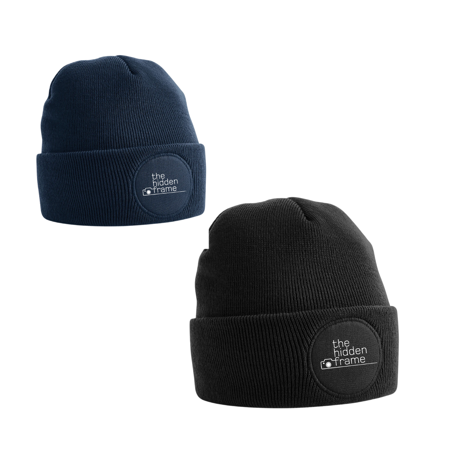 Two cuffed beanies, one navy blue and one black, each featuring a circular patch with white text on the front.