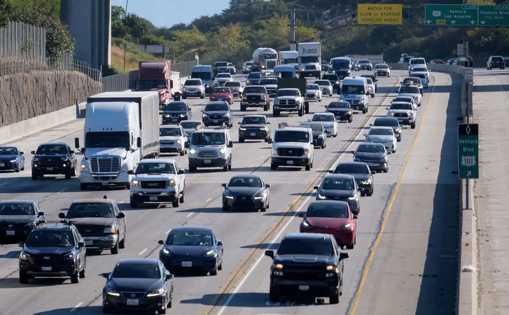 a highway with a lot of cars driving down it