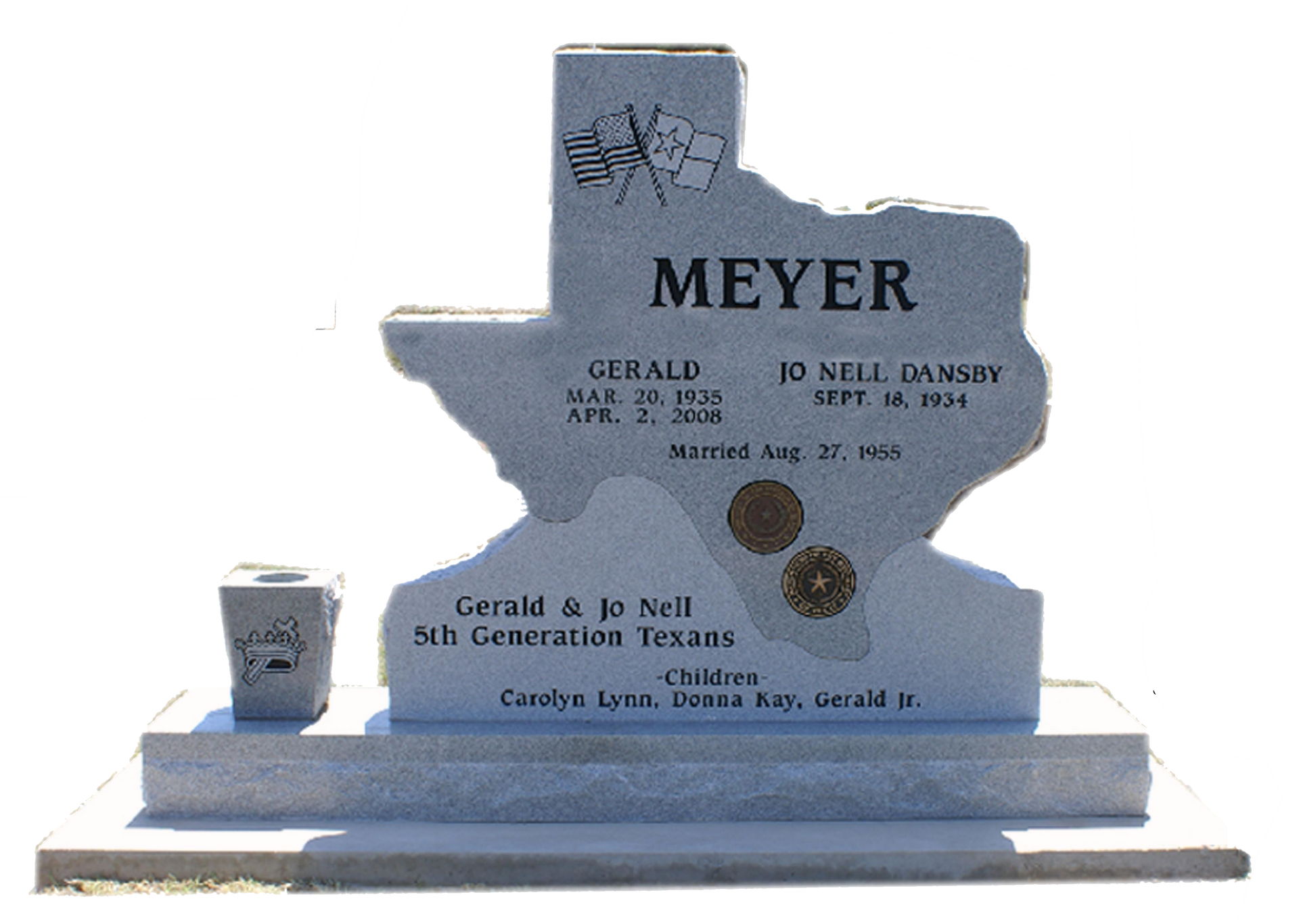 A Texas-shaped granite tombstone for Gerald and Jo Nell Meyer, engraved with names, dates, and family details.