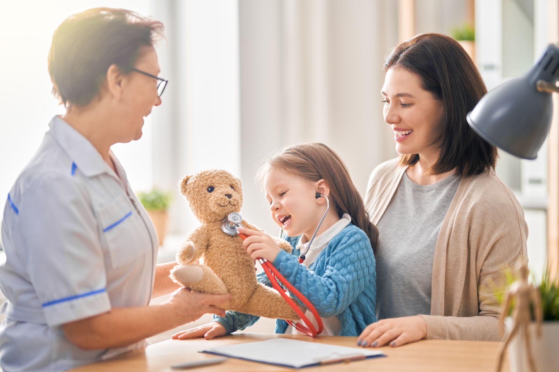 Doctor providing pediatric home care services to a young patient