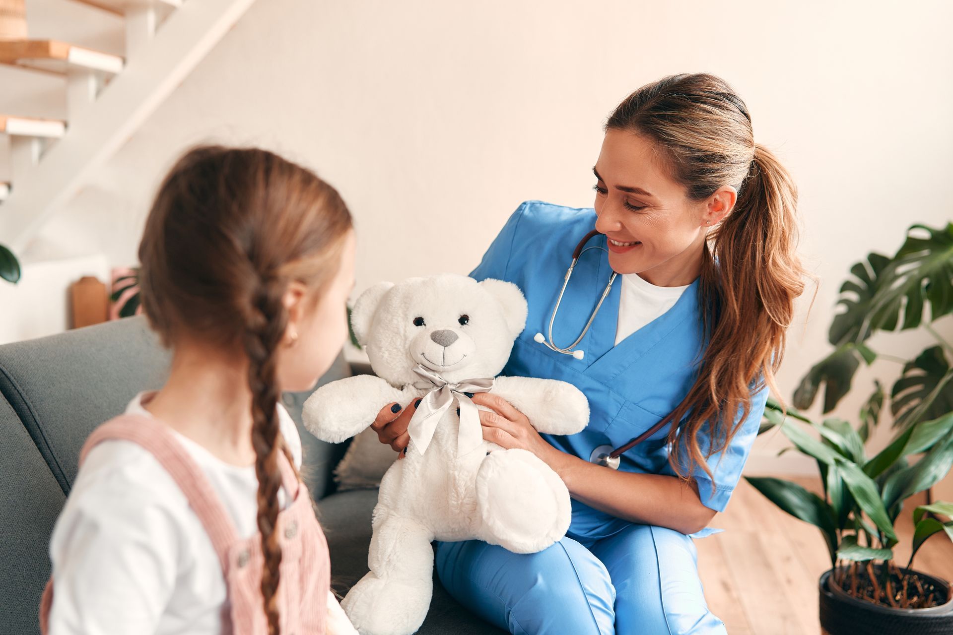 Family doctor visiting a child at home to provide pediatric care services