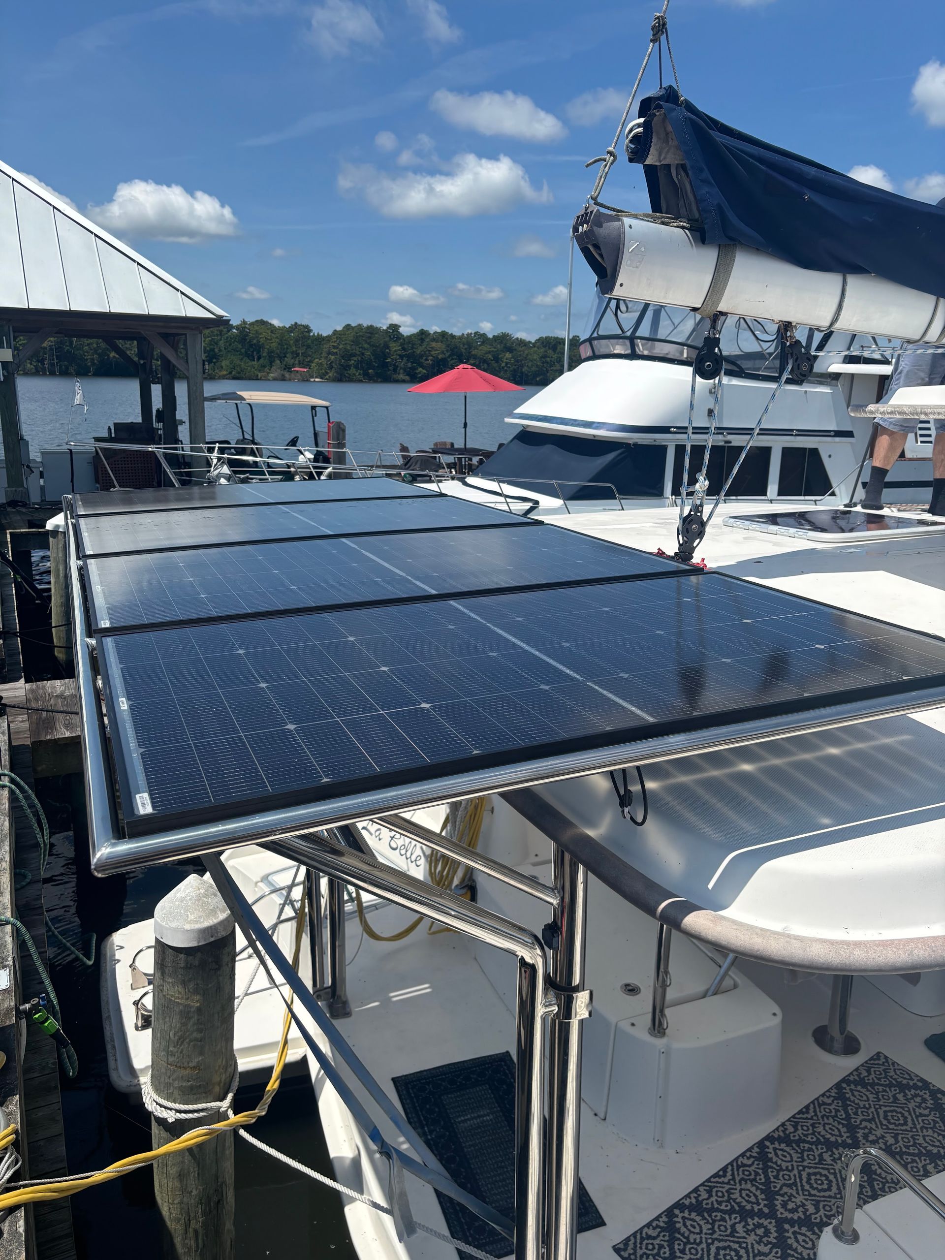 Solar panels mounted on a boat docked at a marina on a sunny day