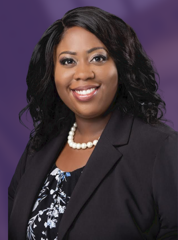 Portrait of a smiling woman in a dark blazer and pearl necklace against a purple background