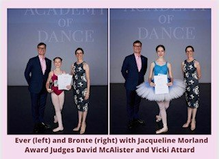 Two ballet dancers with judges. One wears a leotard, the other a tutu. Award presentation in a dance studio.