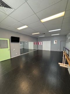 Green studio with Tarkett floor, mirrors, barre