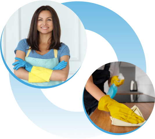 A woman wearing a blue apron and yellow gloves is smiling while cleaning a counter.