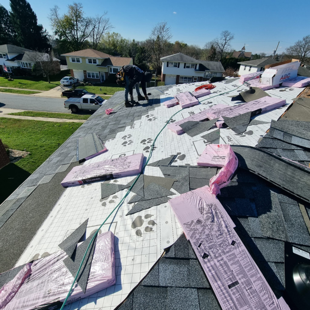 A Man Is Working on The Roof of A House - New Castle, DE - Macedo Mexpro LLC