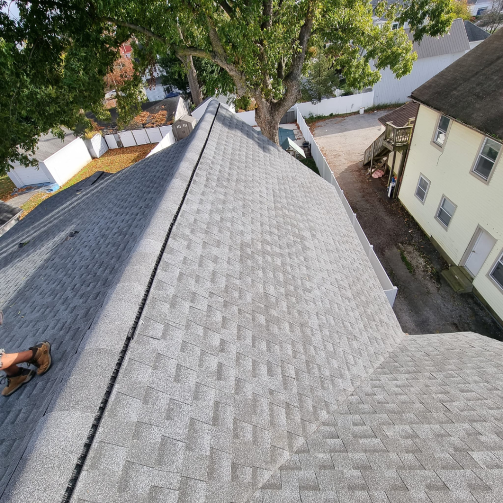 A Person Is Working on The Roof of A House - New Castle, DE - Macedo Mexpro LLC