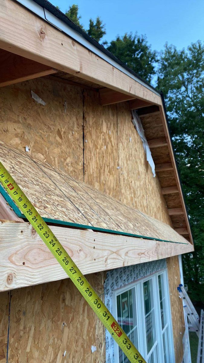 Person Measuring the Roof of a House with a Tape Measure - New Castle, DE - Macedo Mexpro LLC