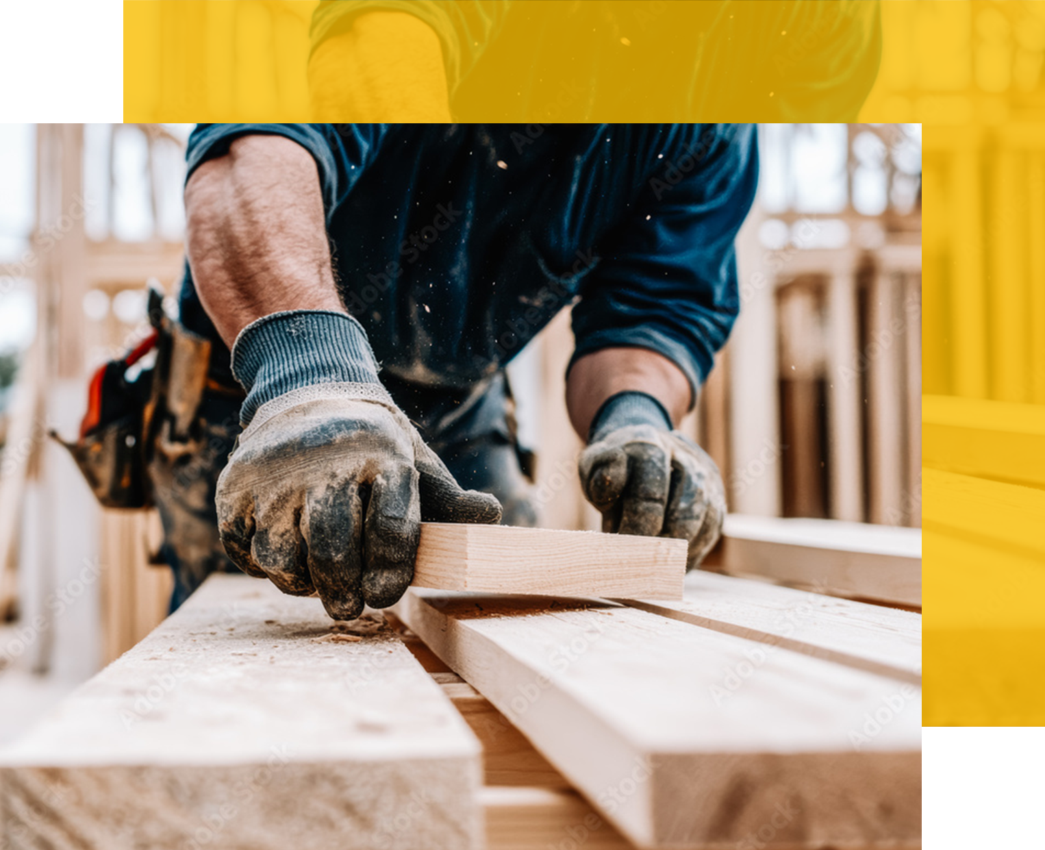 Carpenter using gloved hands to plane a wooden plank, sawdust visible.