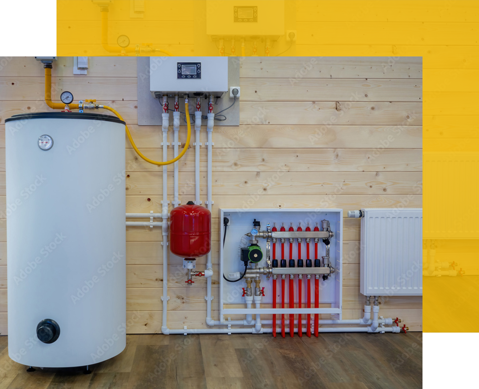 A water heating system with a white tank, pipes, and control panel against wood paneling.