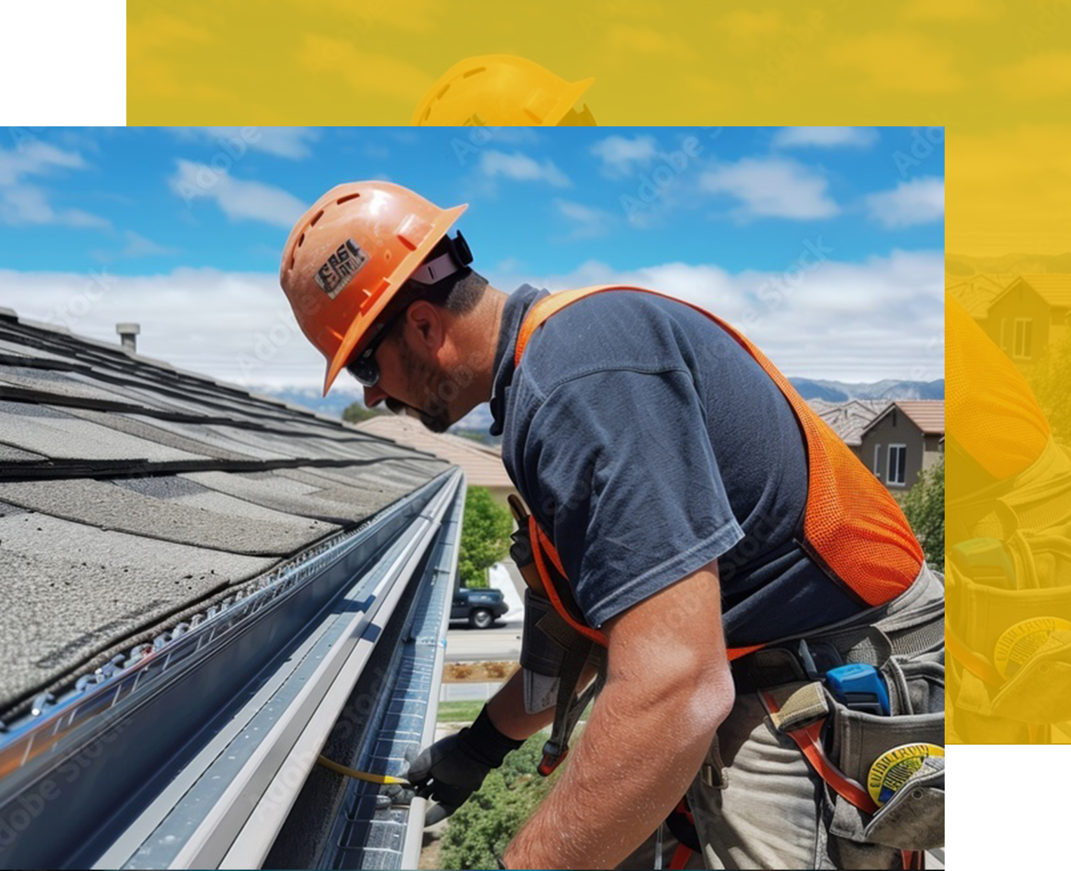 Construction worker cleaning gutters on a roof. Wearing a hard hat and safety vest. Sunny day, blue sky.
