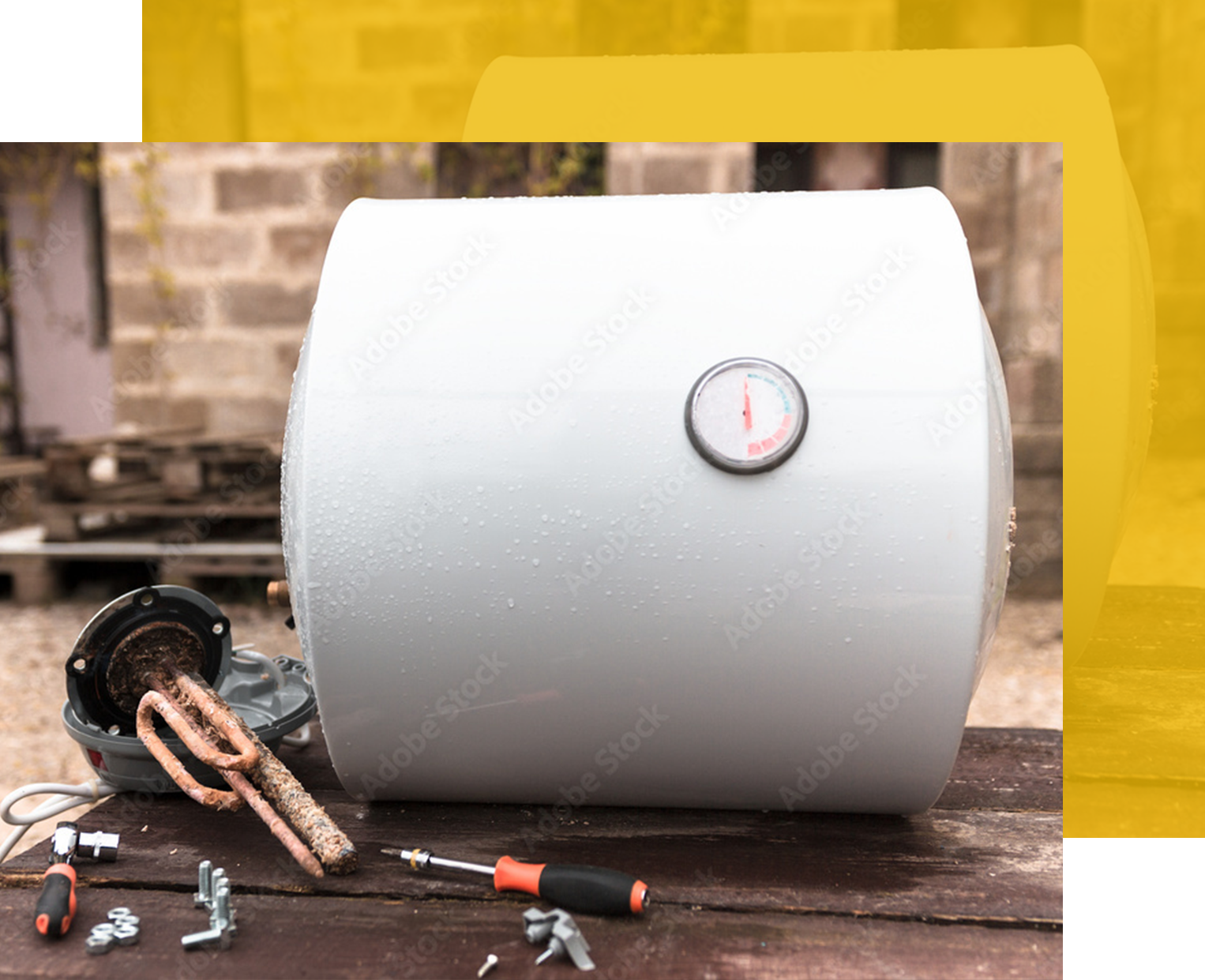 Water heater being repaired, with tools and heating element laid out on a table.