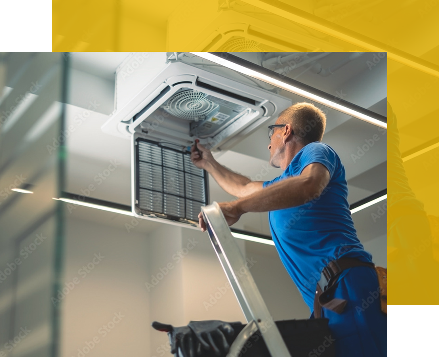 Man on ladder servicing ceiling air conditioning unit.