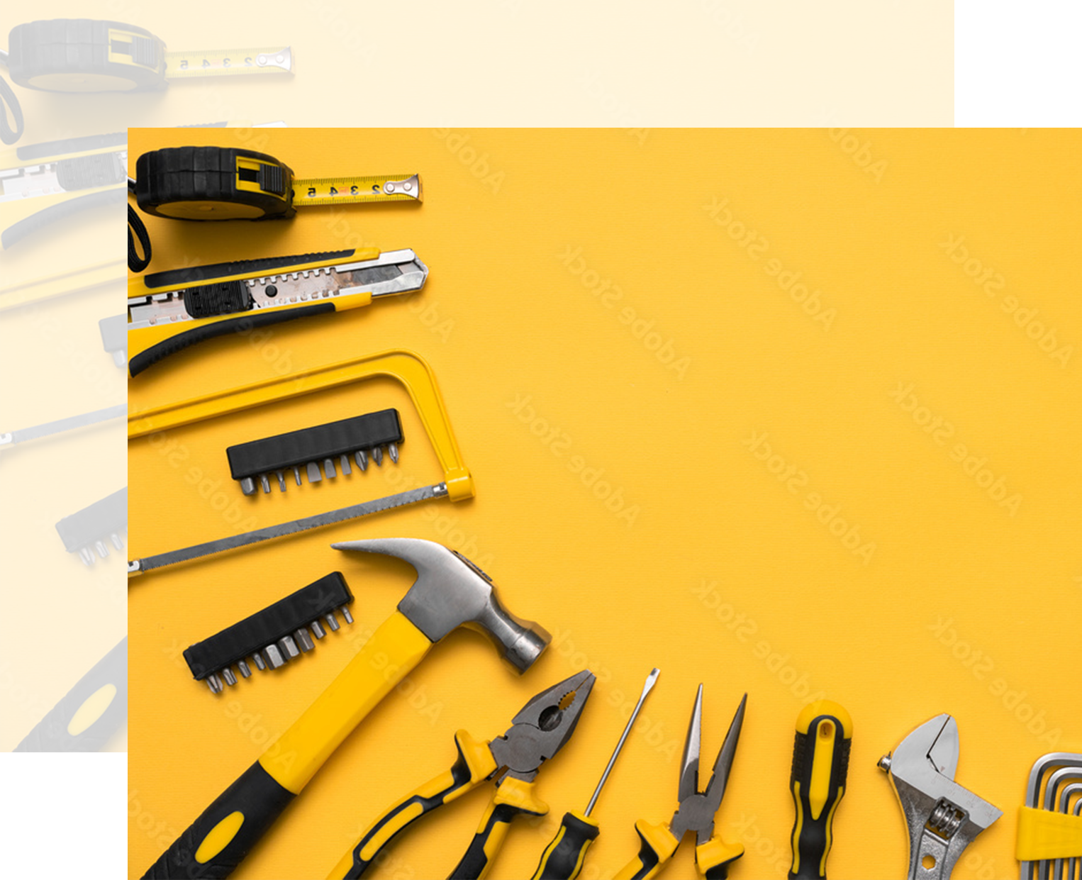 Tools arranged on a yellow surface, including a tape measure, hammer, and pliers.