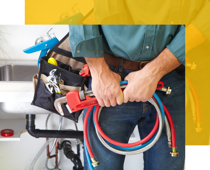Plumber holding hoses, standing near a sink with tools.