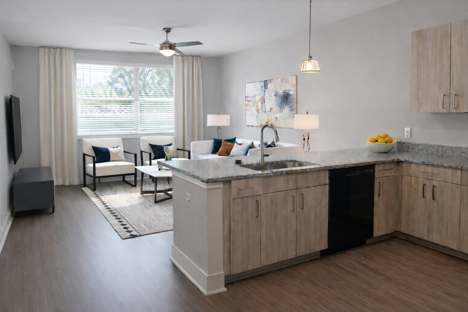 Open-concept kitchen with granite countertops and a connected living area.