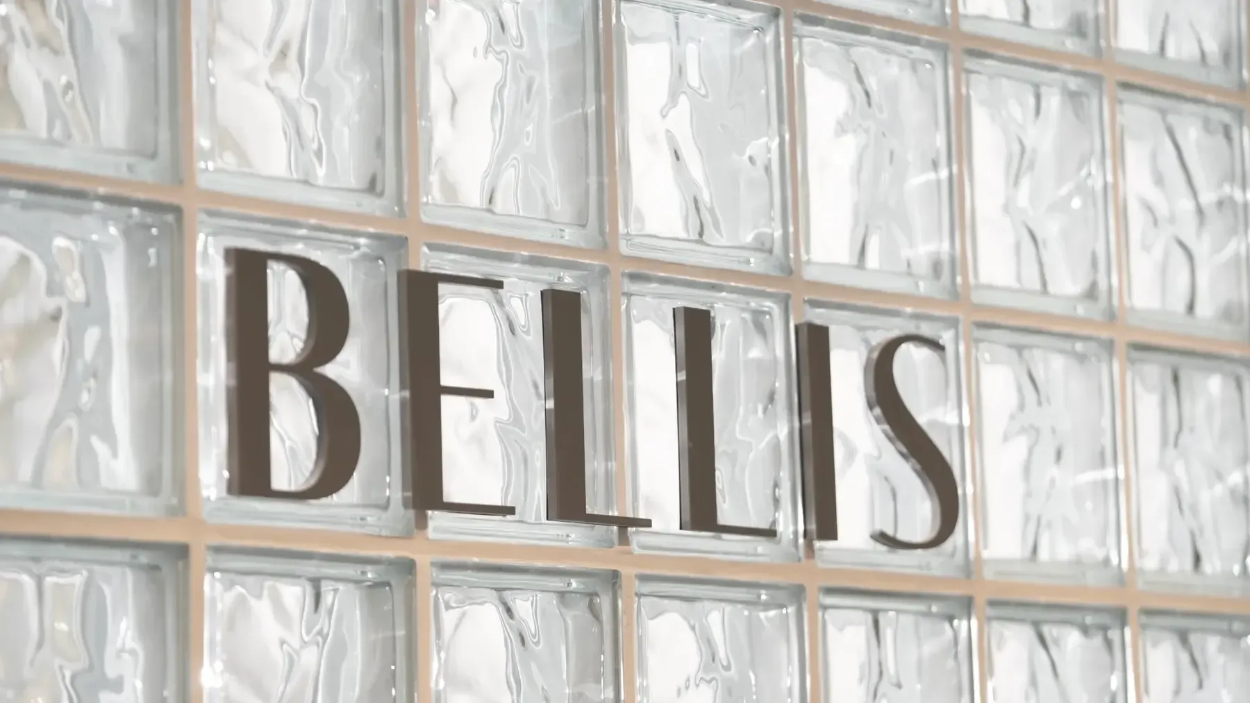 Bellis Clinic sign on the glass-block feature wall