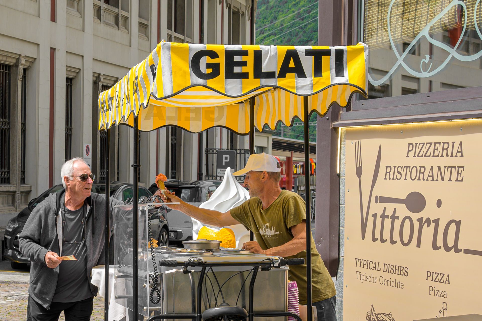 Un uomo è in piedi davanti a un carretto dei gelati