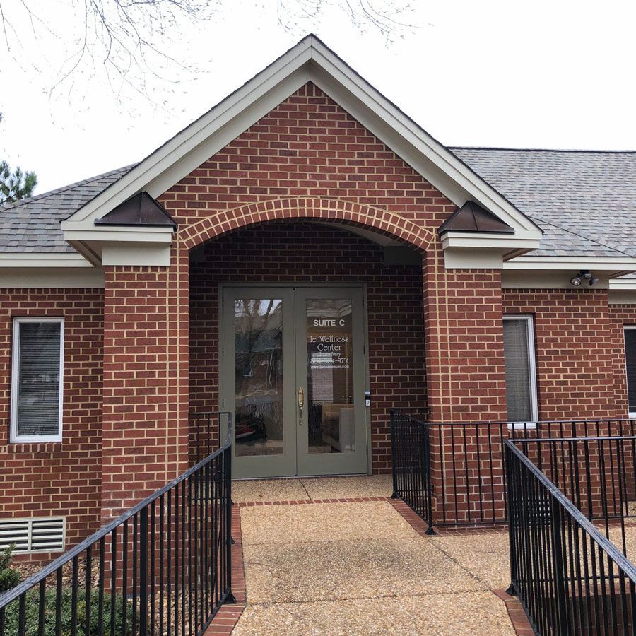A brick building with a ramp leading to the front door