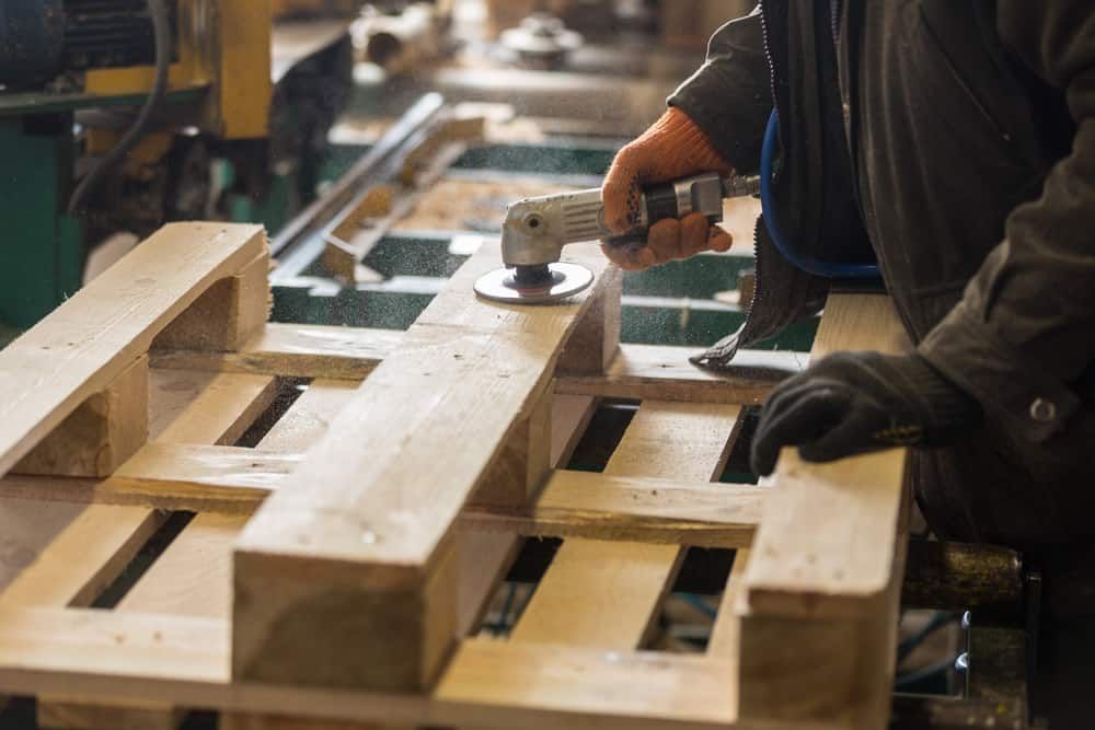 Sanding Down Wood Pallet With Electric Sander
