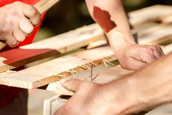 Hammering Nail In Wood Pallet