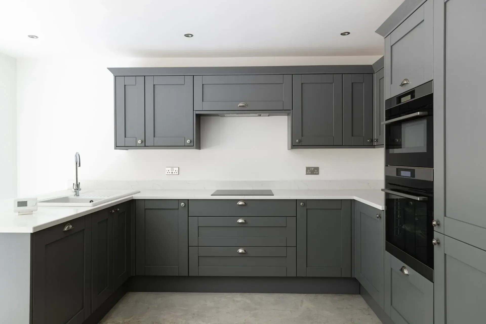 Gray kitchen with cabinetry, countertops, and appliances.