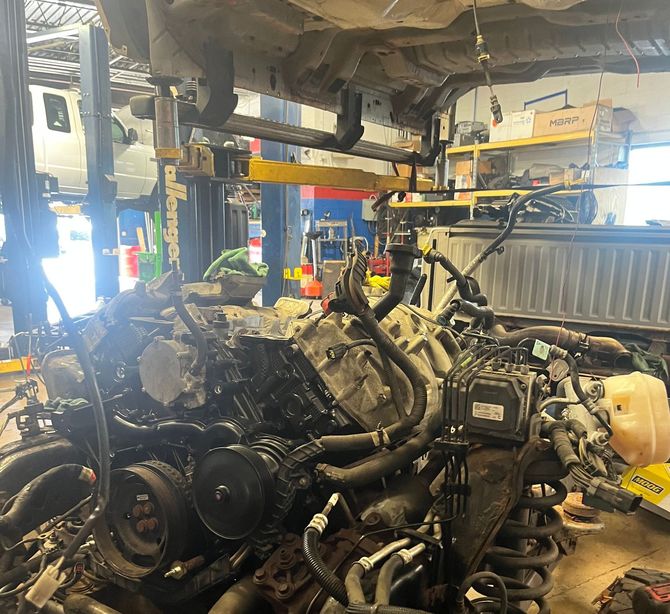 A car engine is being worked on in a garage