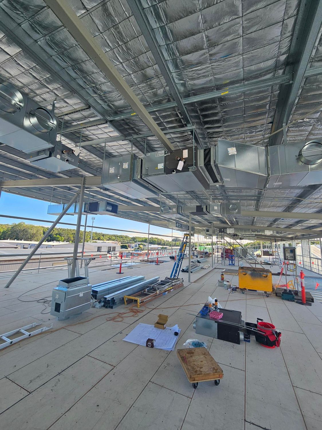 An Industrial Work Site With Ladders and Materials On the Ground — Frigid-Air PTY Ltd In South Lismore, NSW