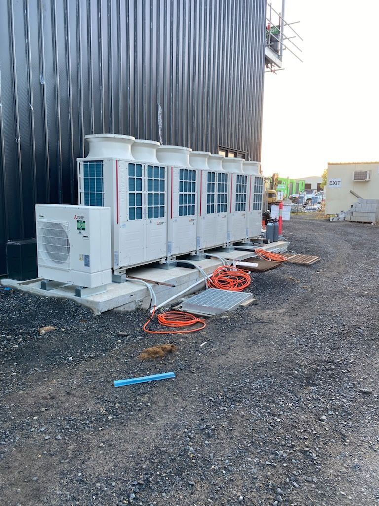 A Set Of Air Conditioning Units Beside Each Other Outside A Building — Frigid-Air PTY Ltd In South Lismore, NSW