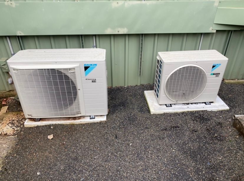 A Large Air Conditioner is Being Installed on the Side of a Building — Frigid-Air PTY Ltd. in South Lismore, NSW