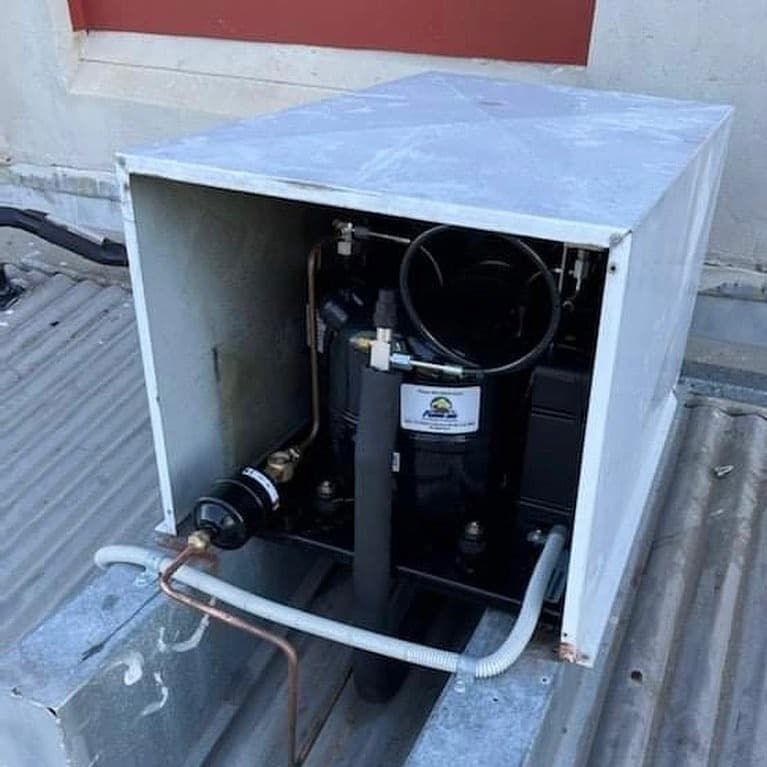 Open Metal Box on a Corrugated Rooftop