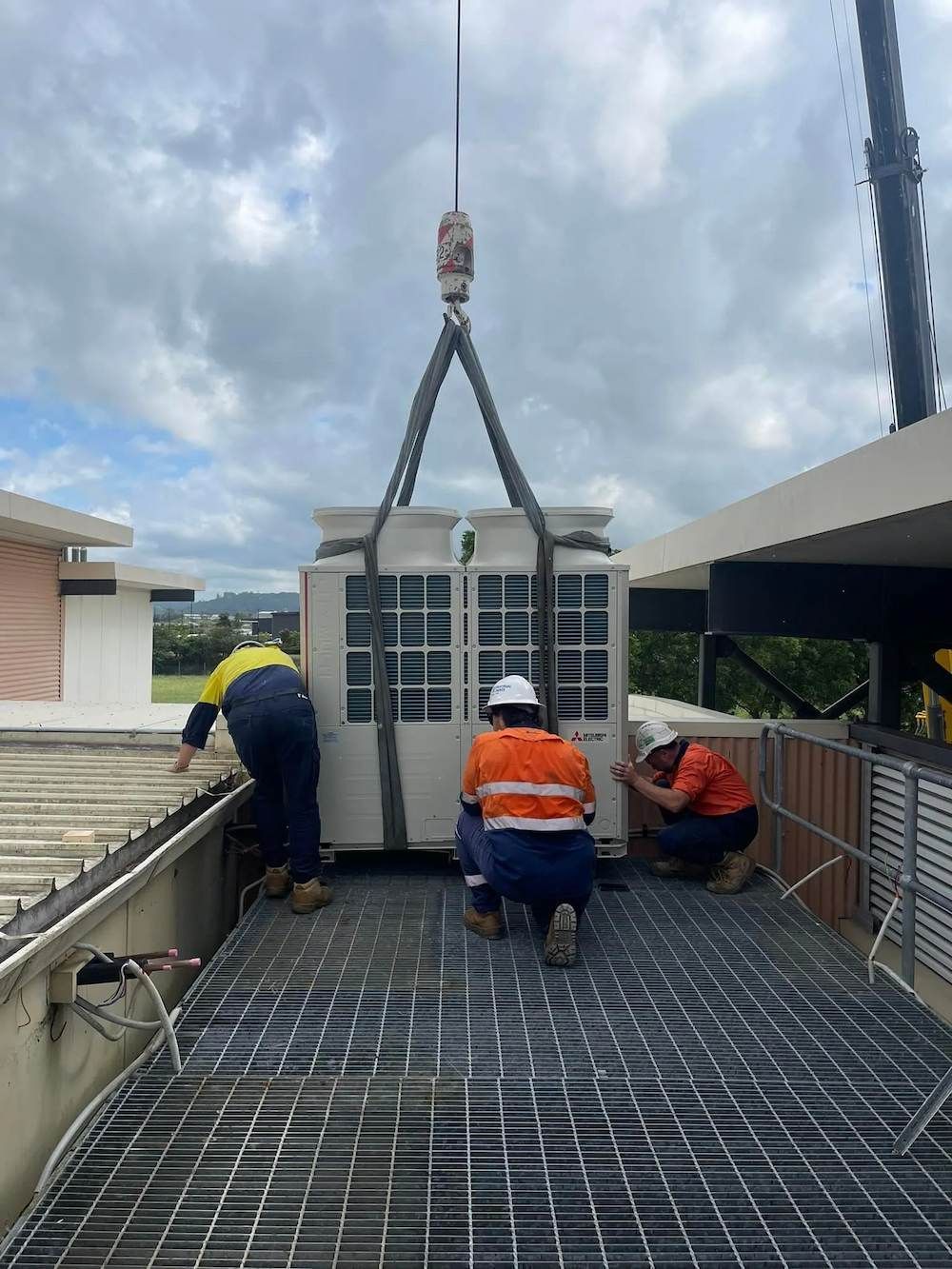 Technicians Installing Rooftop Air Conditioning In Byron Bay