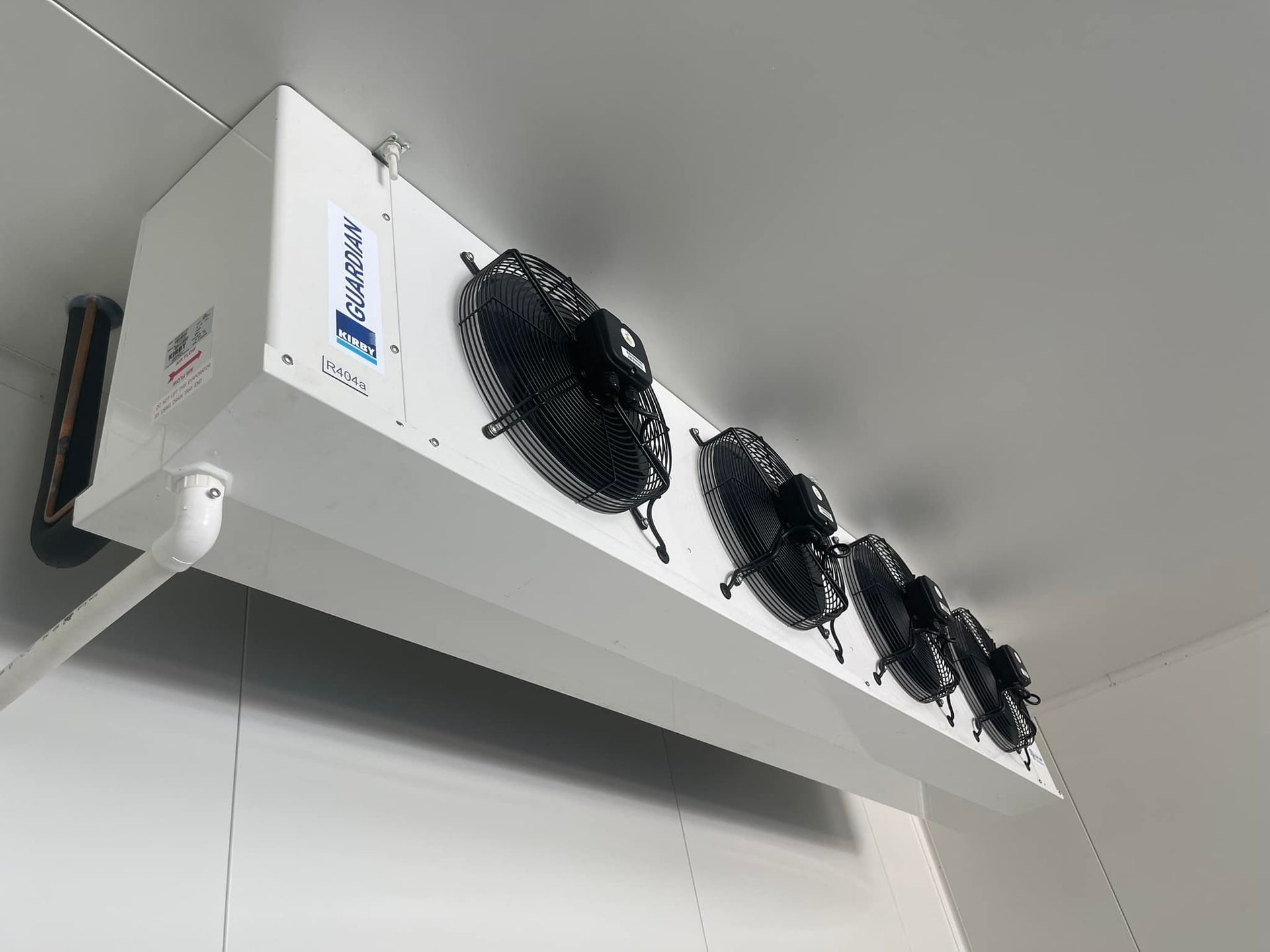 A White Box With Black Fans Hanging From The Ceiling Of A Room — Frigid-Air PTY Ltd In Bangalow, NSW