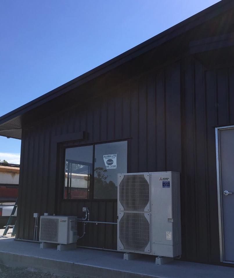 A Building With Two Air Conditioners On The Side Of It — Frigid-Air PTY Ltd In Bangalow, NSW