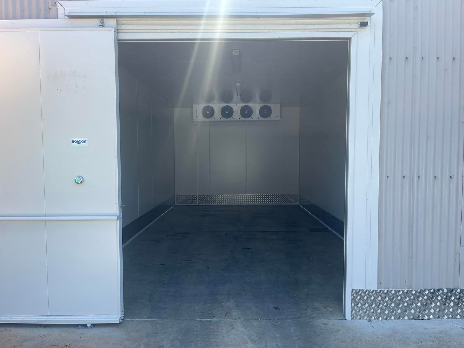 A Large Empty Room With A Sliding Door Open — Frigid-Air PTY Ltd In Bangalow, NSW