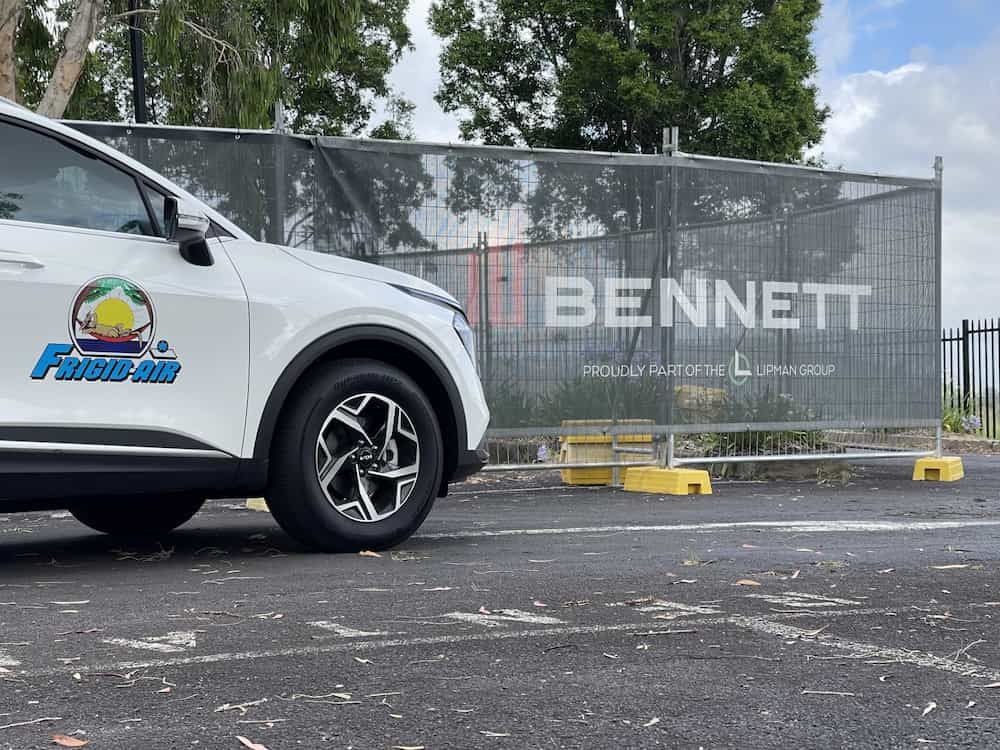 White Car Is Parked In Front Of A Bennett Sign — Frigid-Air PTY Ltd In South Lismore, NSW