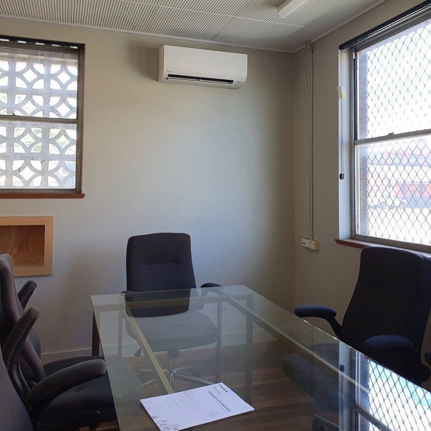 A Conference Room With A Glass Table And Chairs — Frigid-Air PTY Ltd In Bangalow, NSW