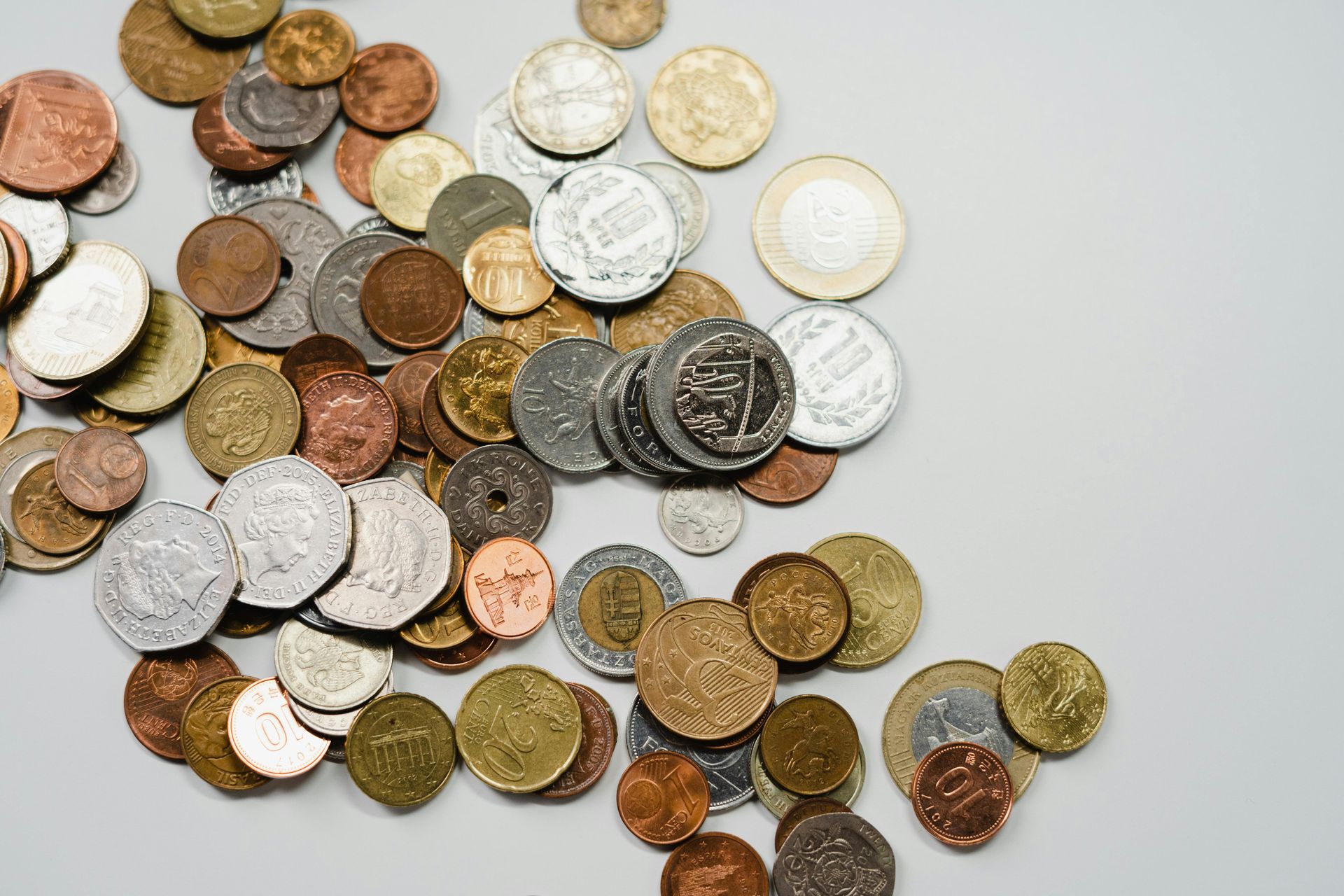 A bunch of coins are scattered on a table