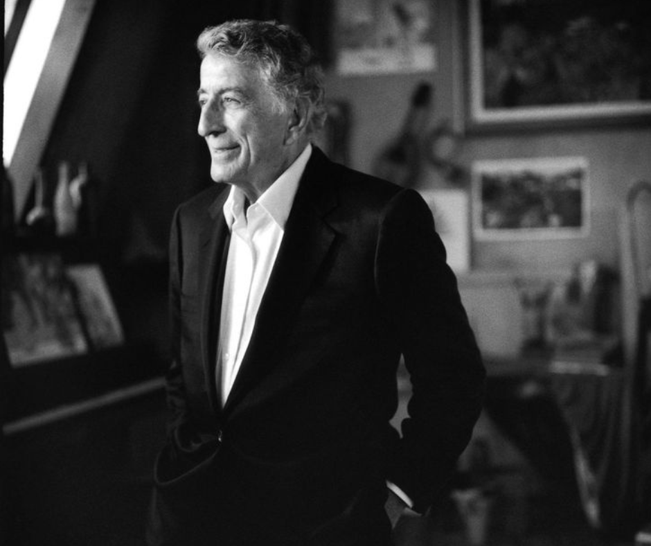 A black and white photo of a man in a suit
