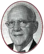 A black and white photo of a man wearing glasses and a bow tie.