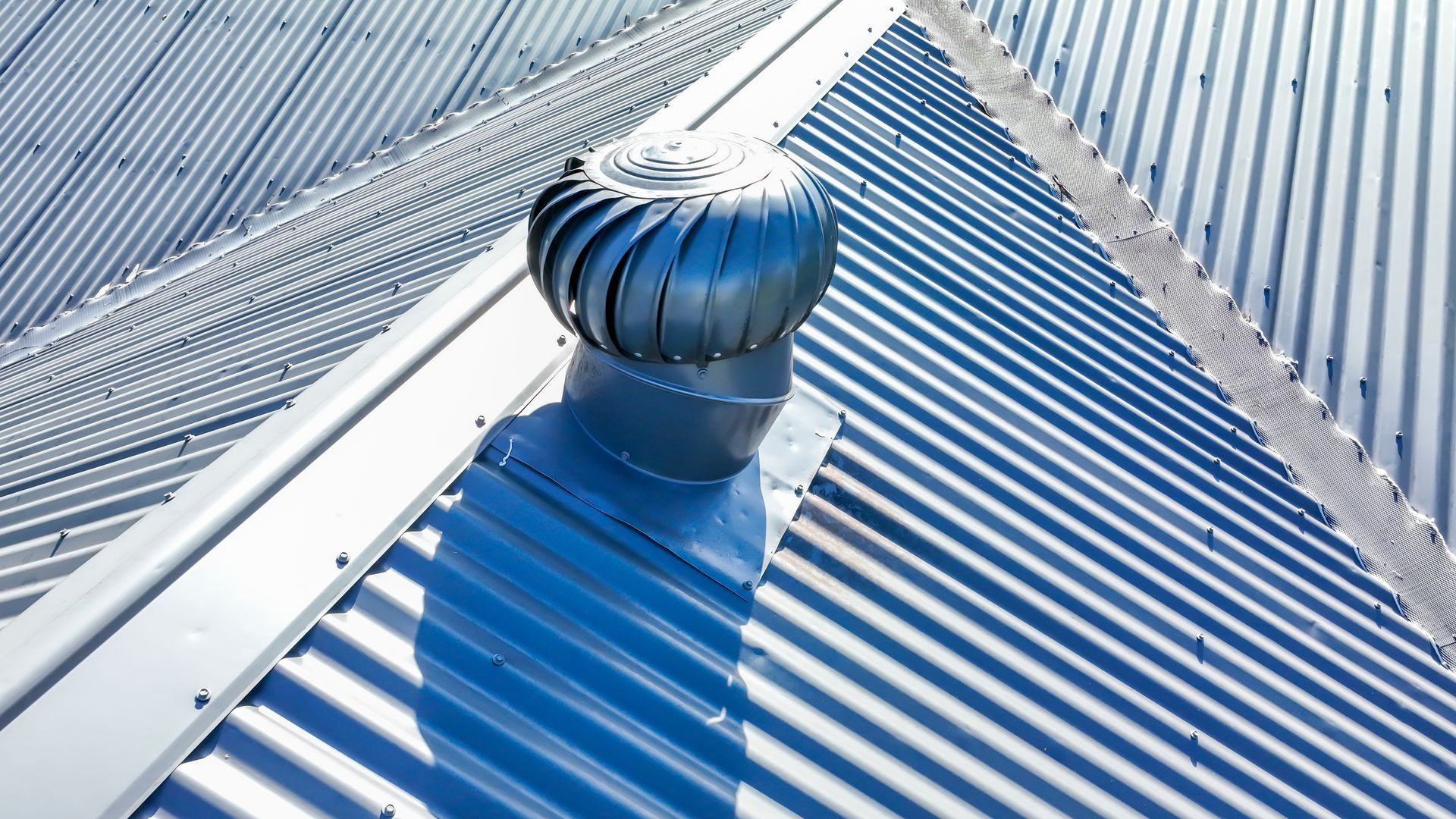 Rooftop Turbine Ventilator on a Metal Roof, Casting Long Parallel Shadows — Callaway Roofing & Construction in Bourke, NSW