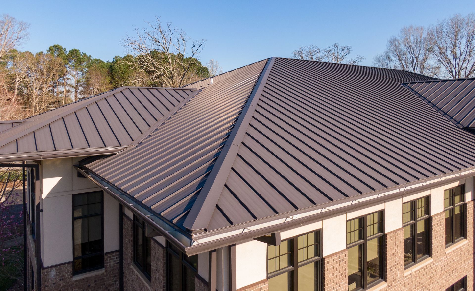 Dark Gray Metal Roof on a Building With Brick and White Walls — Callaway Roofing & Construction in Narrabri, NSW