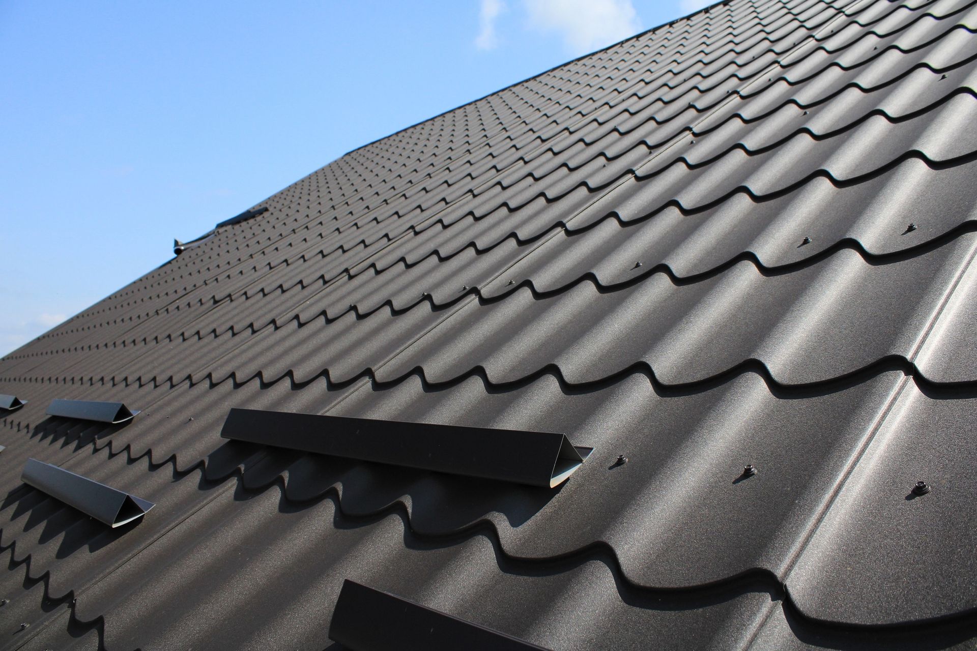 Black Metal Roof With Wavy Texture and Ventilation Vents — Callaway Roofing & Construction in Tamworth, NSW