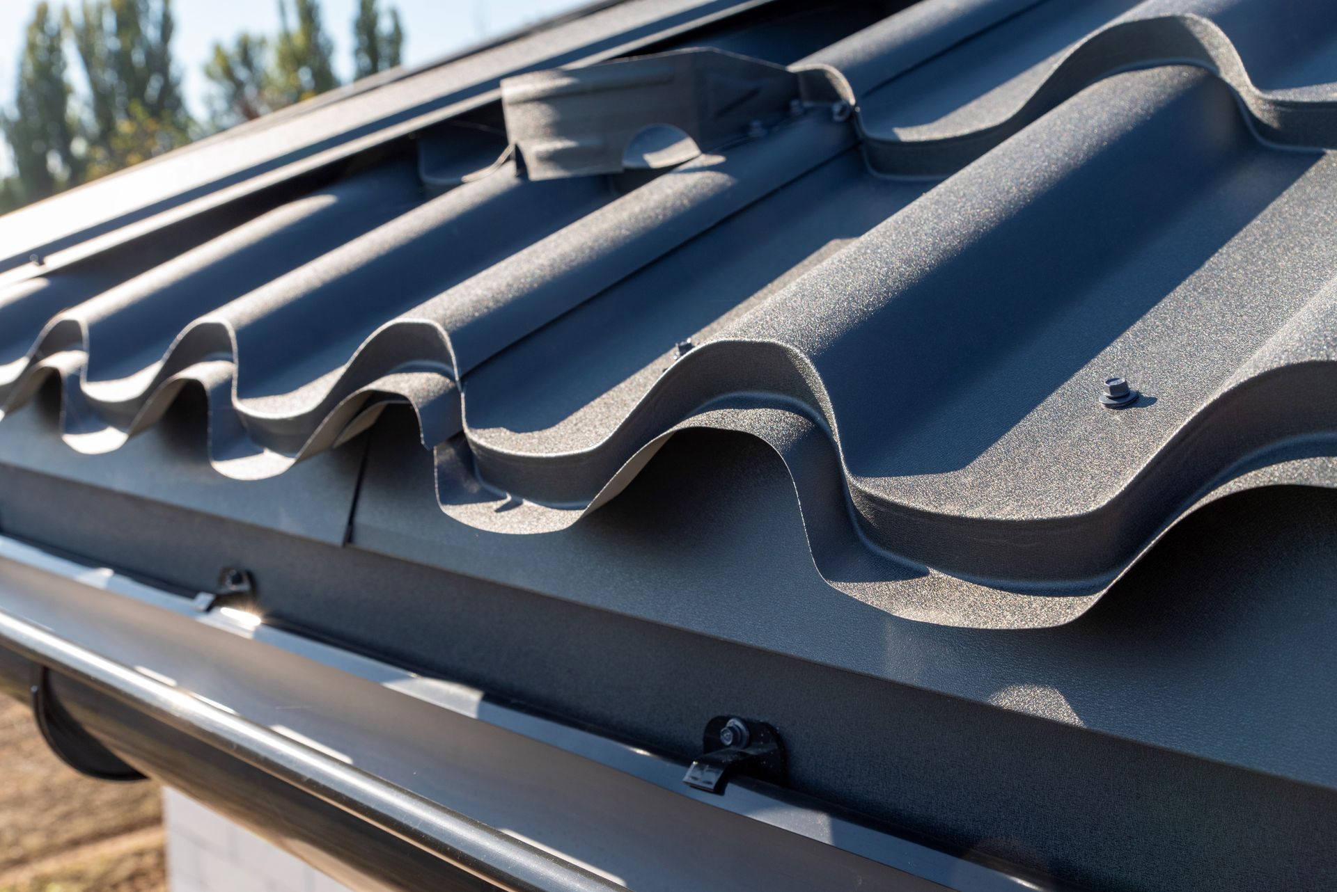 Black Metal Roof With Matching Gutter and Downspout — Callaway Roofing & Construction in Gilgandra, NSW