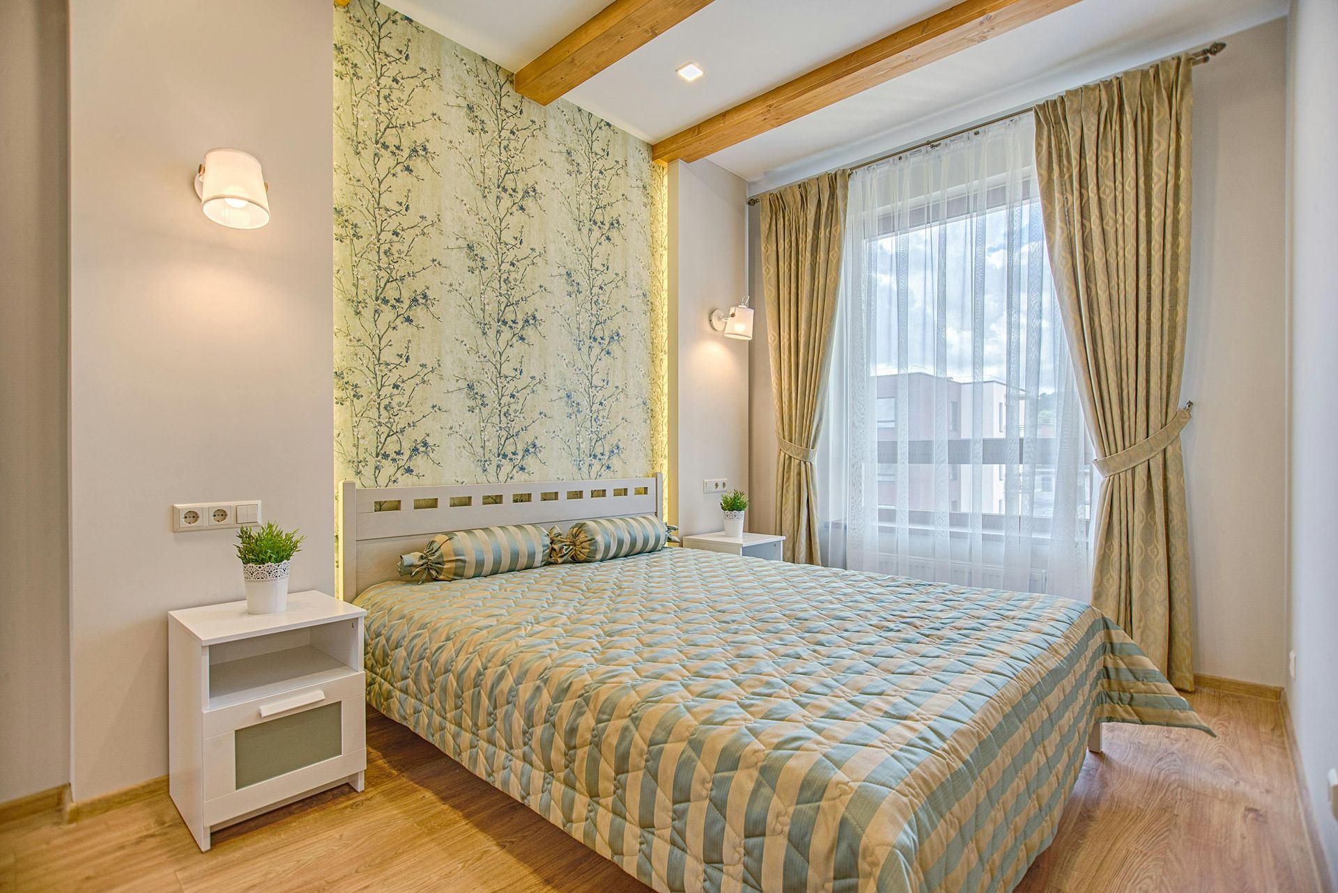 A bedroom with a bed , nightstand , and window.