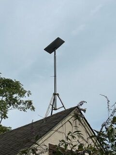 Satellite dish is sitting on top of a roof