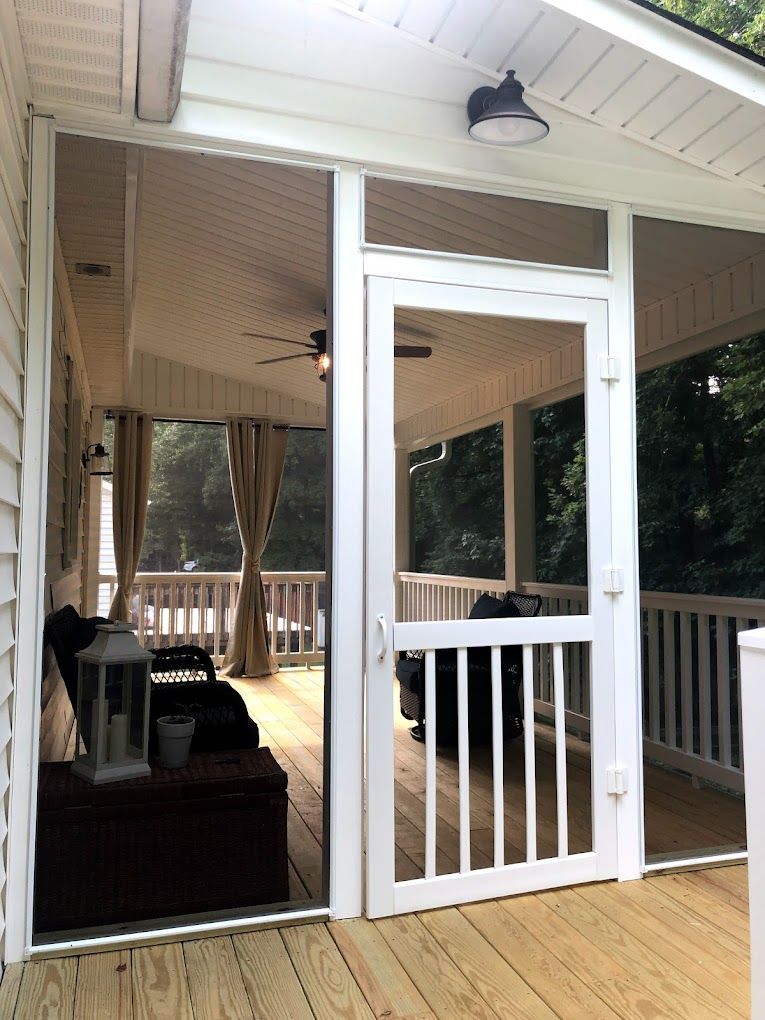 A screened in porch with a sliding glass door