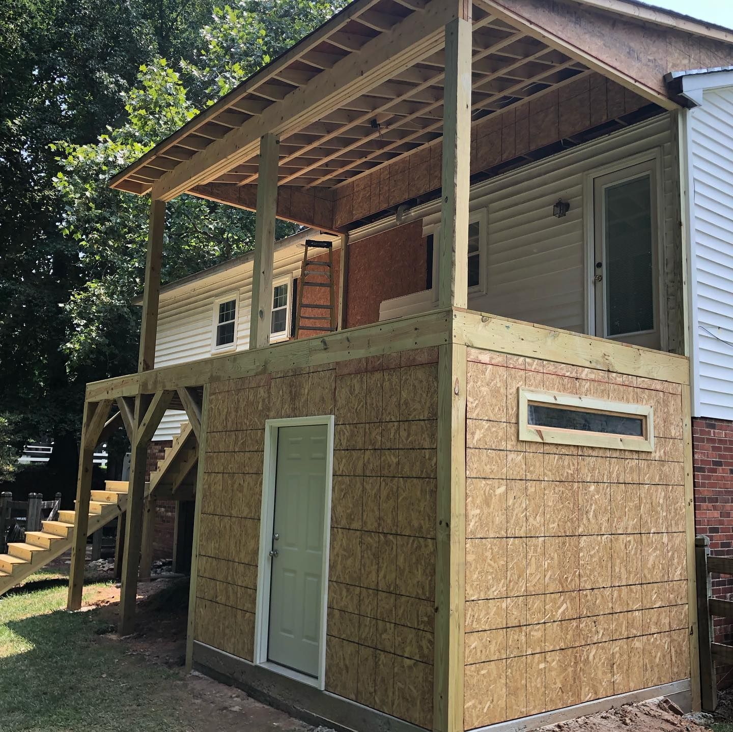 A house with a wooden deck on top of it