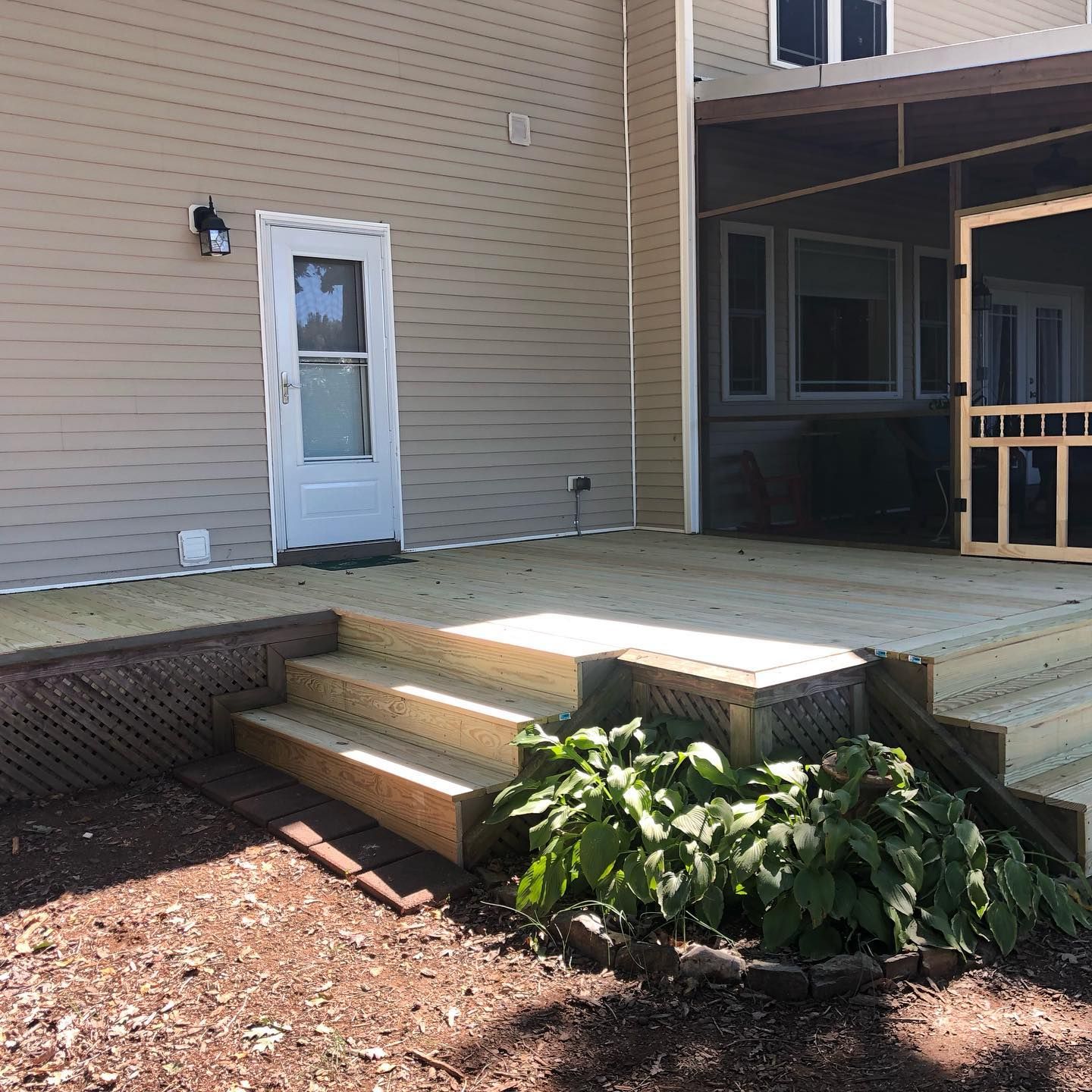 A house with a screened in porch and stairs